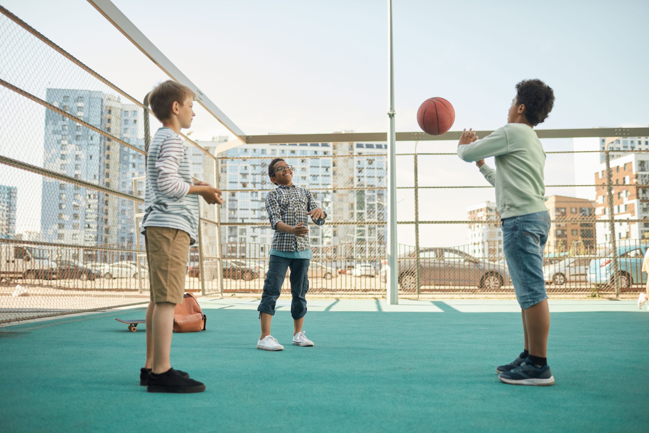 Kids playing basketball outdoors, representing back to school and sports physicals at The Village Family Medicine