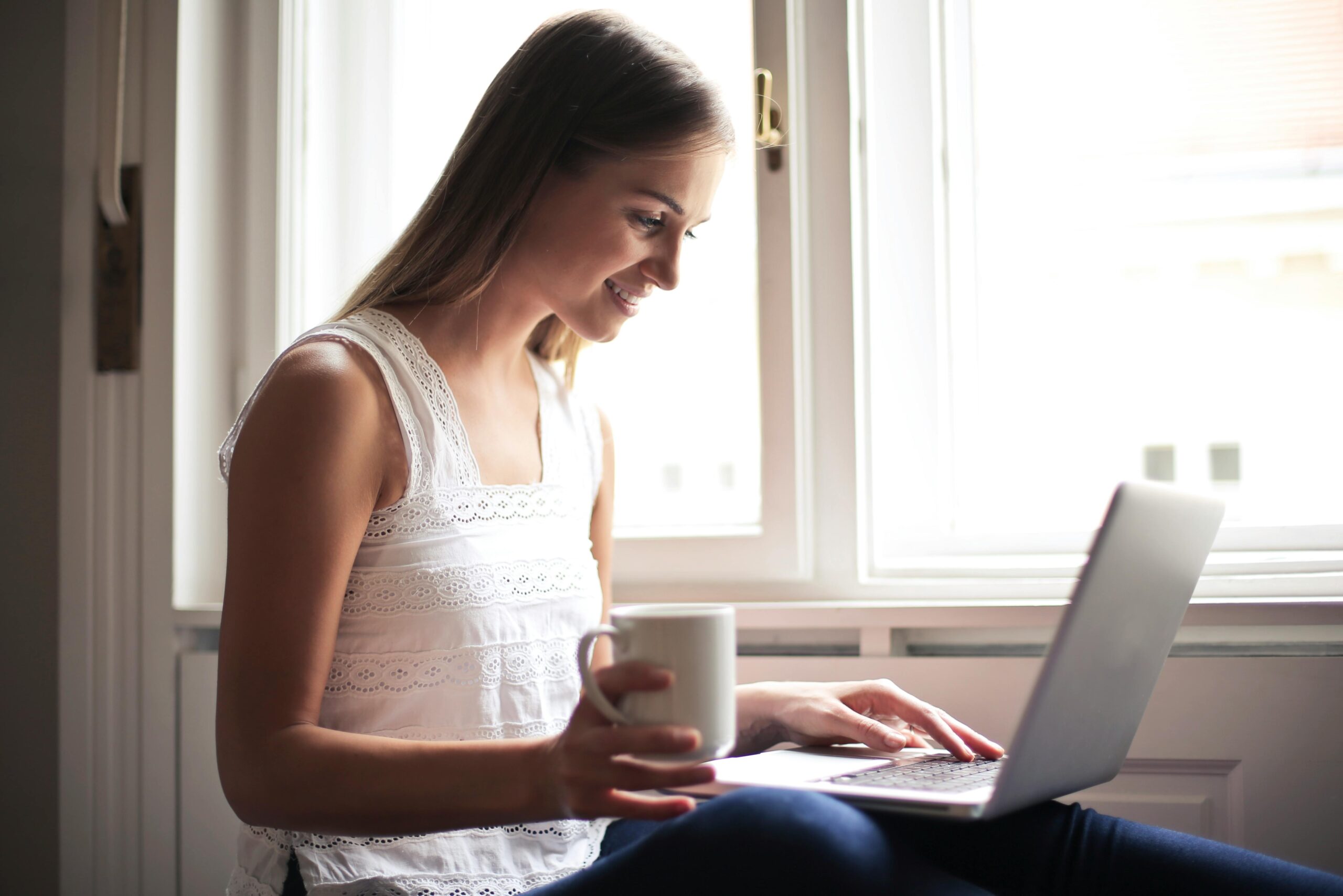 Woman researching Direct Primary Care versus traditional insurance options on her laptop at home